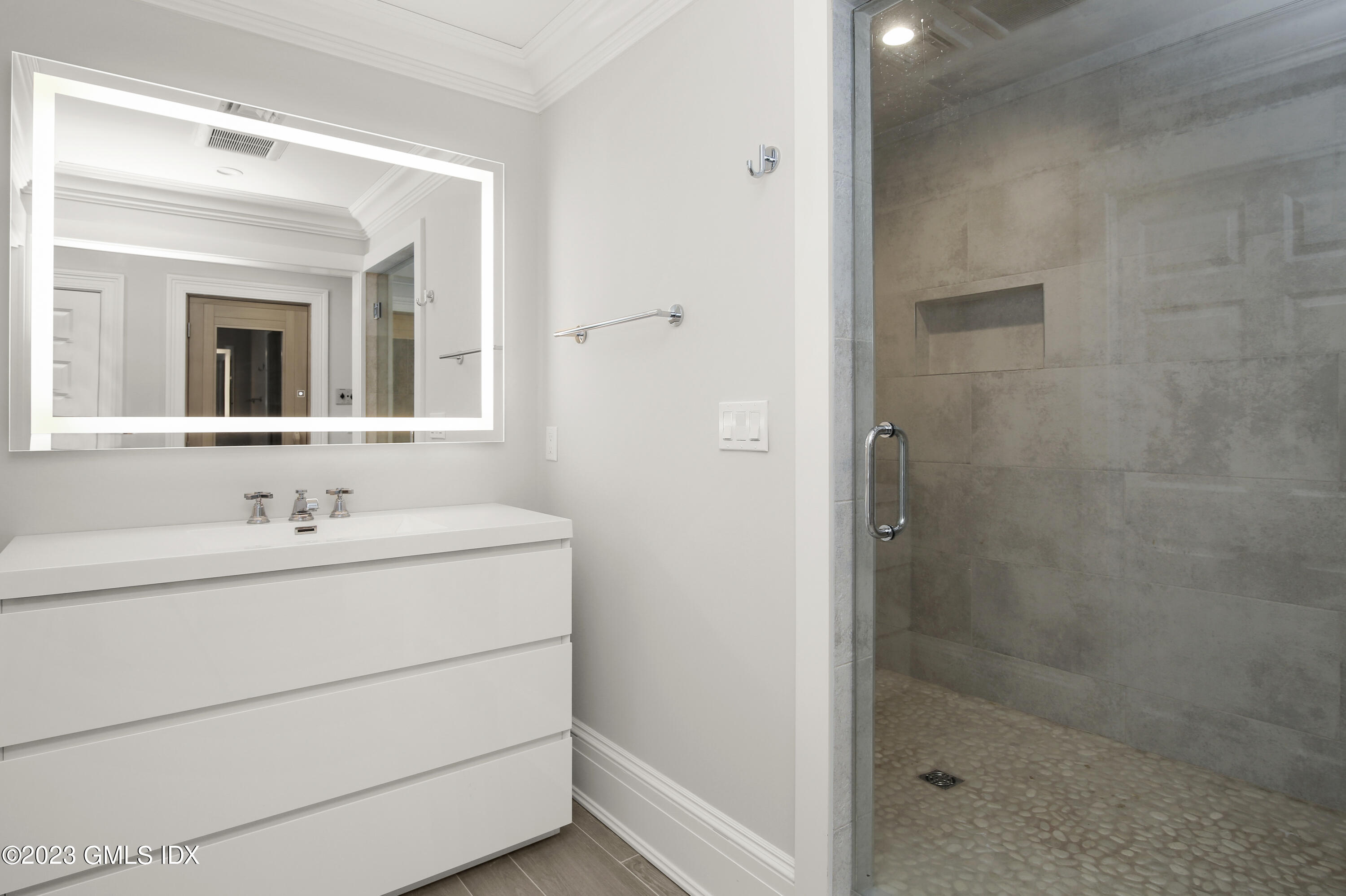 39 Boulder Brook Road Greenwich, CT 06830 - Photo 44 of 55 a bathroom with a sink a mirror and shower