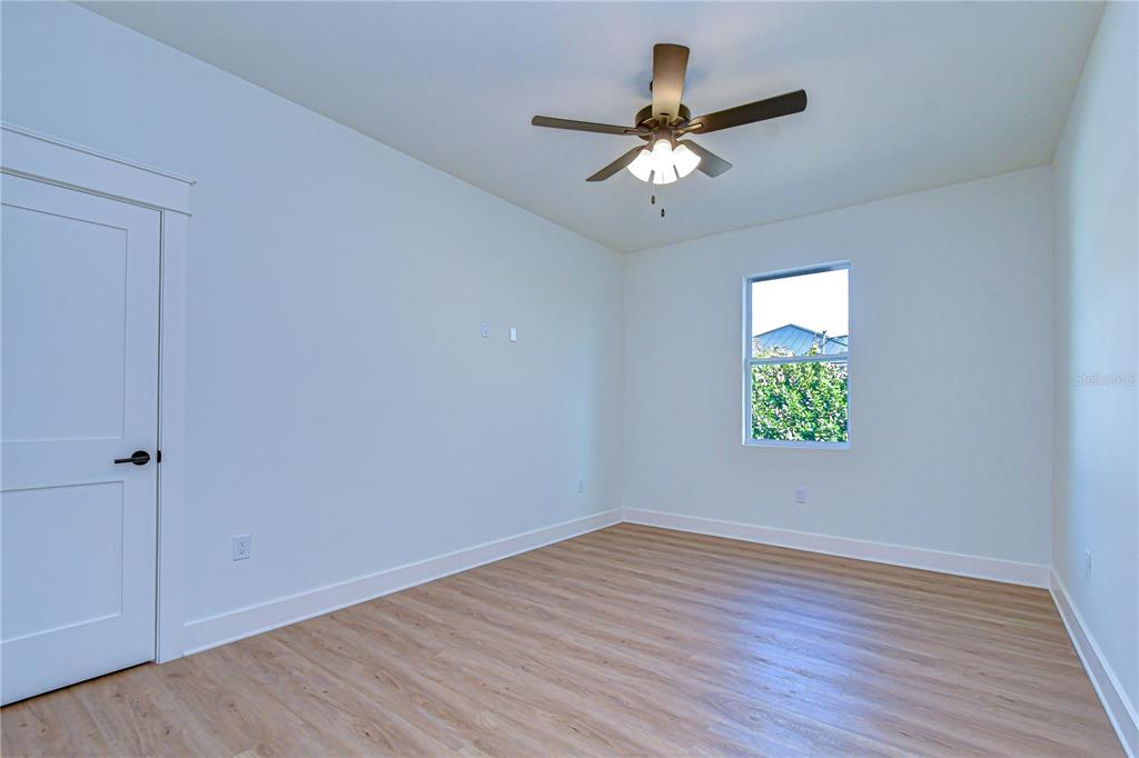 3213 West Aileen Street Tampa, FL 33607 - Photo 12 of 31 wooden floor in an empty room with a window