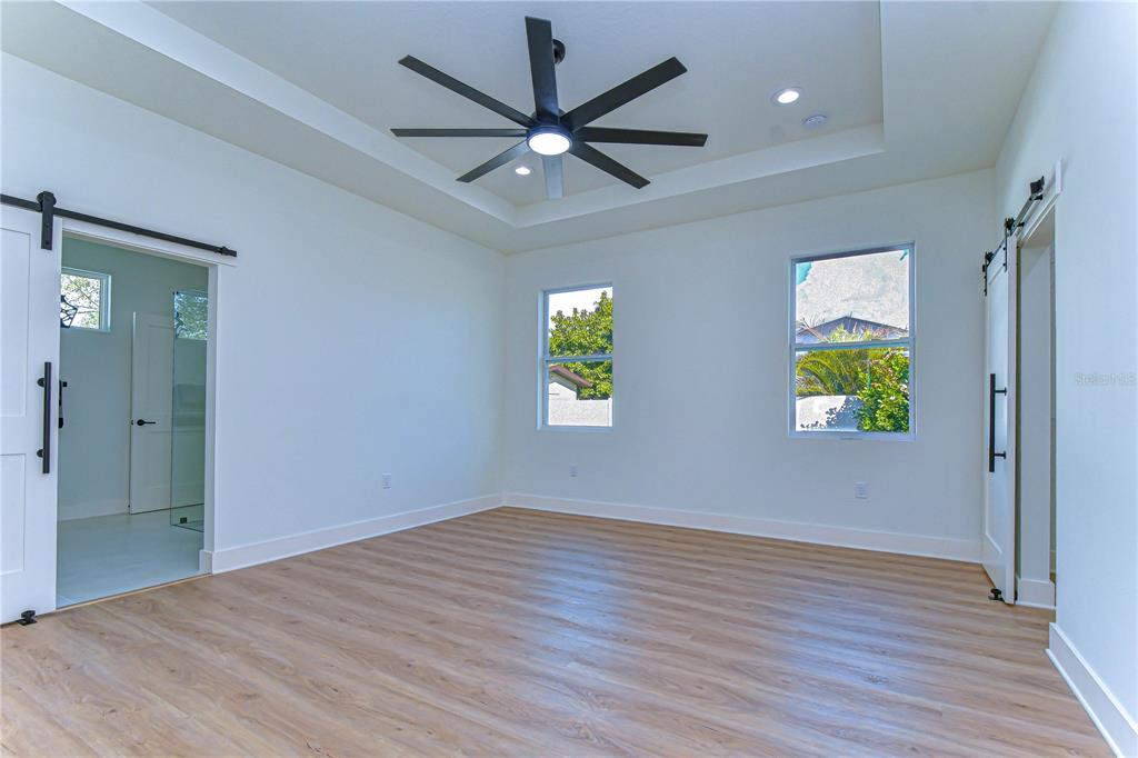 3213 West Aileen Street Tampa, FL 33607 - Photo 14 of 31 wooden floor in an empty room with a window