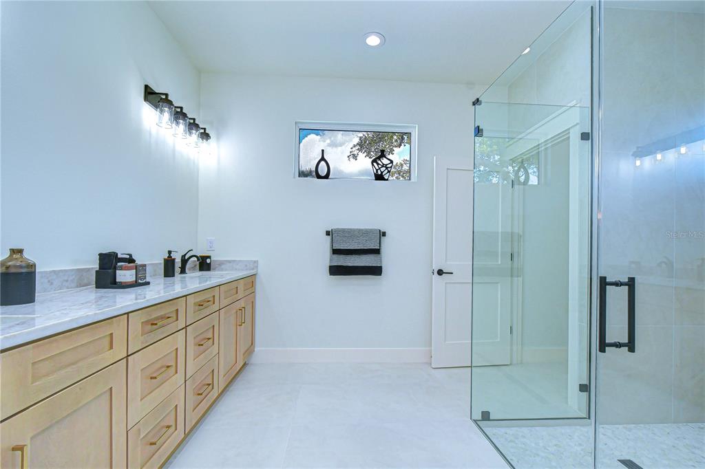 3213 West Aileen Street Tampa, FL 33607 - Photo 15 of 31 a bathroom with a double vanity sink and a mirror