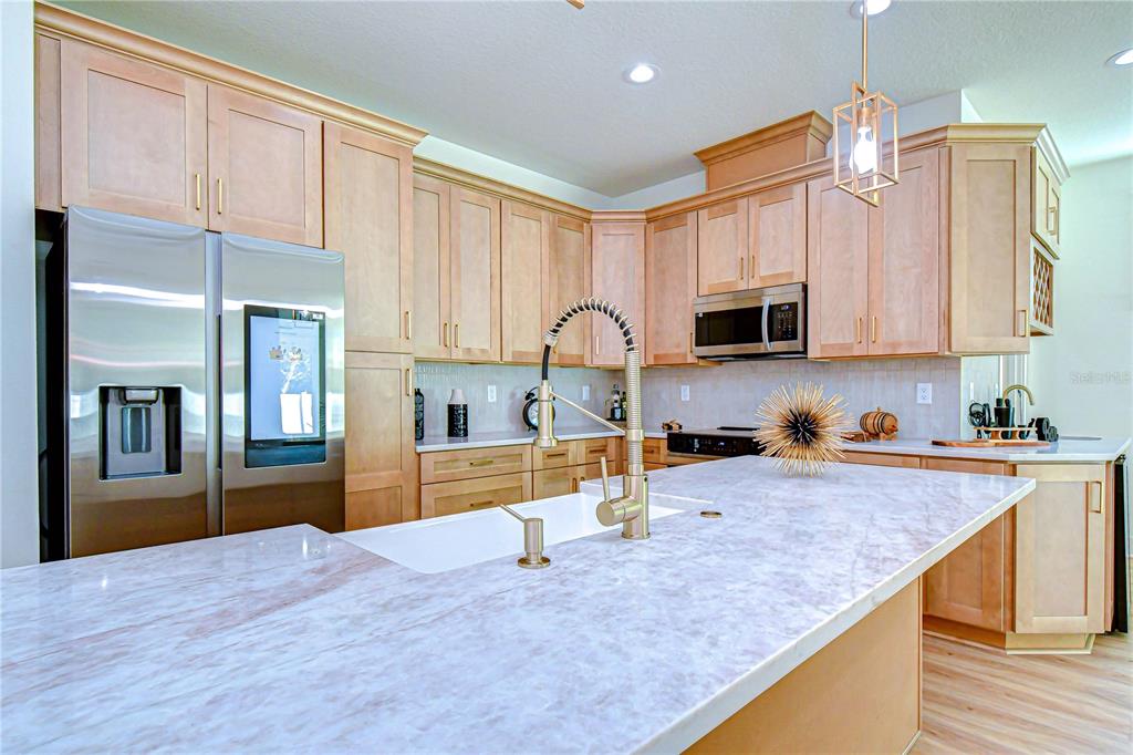 3213 West Aileen Street Tampa, FL 33607 - Photo 18 of 31 a kitchen with stainless steel appliances granite countertop a stove refrigerator sink and cabinets