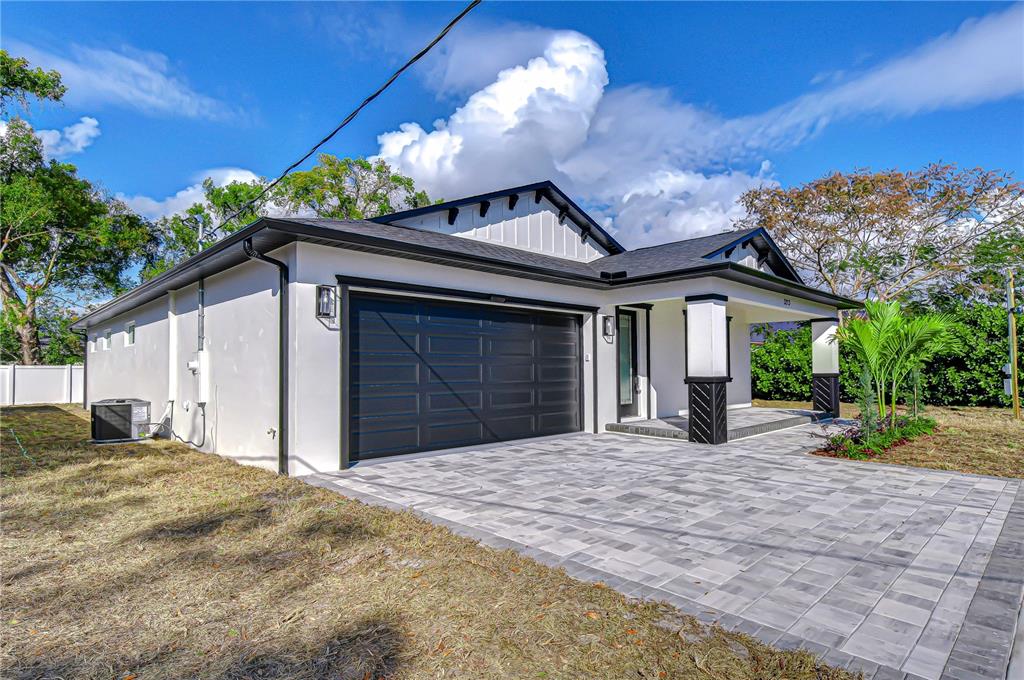 3213 West Aileen Street Tampa, FL 33607 - Photo 2 of 31 a front view of a house with a yard and garage