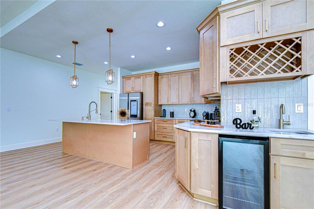 3213 West Aileen Street Tampa, FL 33607 - Photo 24 of 31 a kitchen with stainless steel appliances granite countertop a sink a stove a refrigerator and island with wooden floors