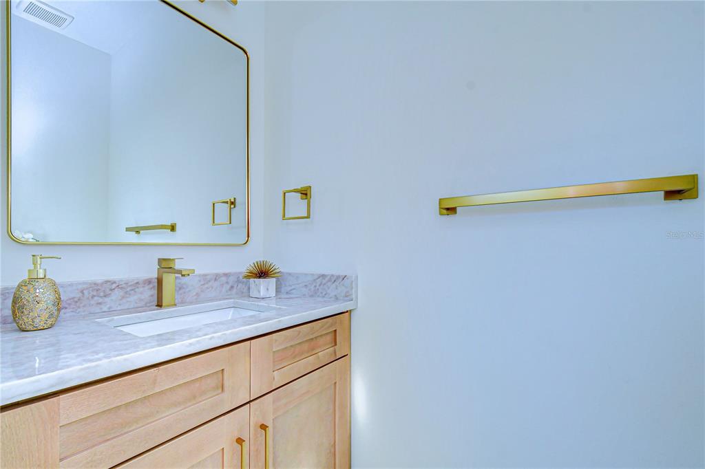 3213 West Aileen Street Tampa, FL 33607 - Photo 28 of 31 a bathroom with a granite countertop sink and a mirror