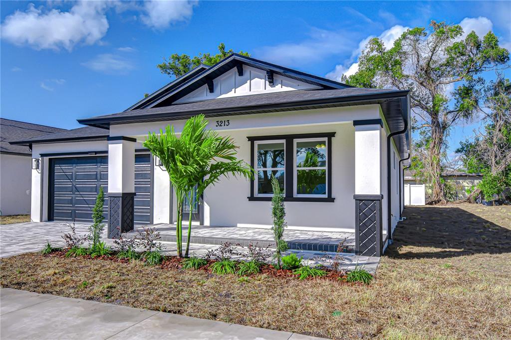 3213 West Aileen Street Tampa, FL 33607 - Photo 3 of 31 a front view of a house with garden