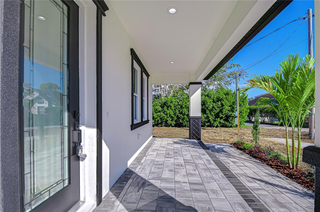 3213 West Aileen Street Tampa, FL 33607 - Photo 5 of 31 a view of a porch with wooden floor and stairs