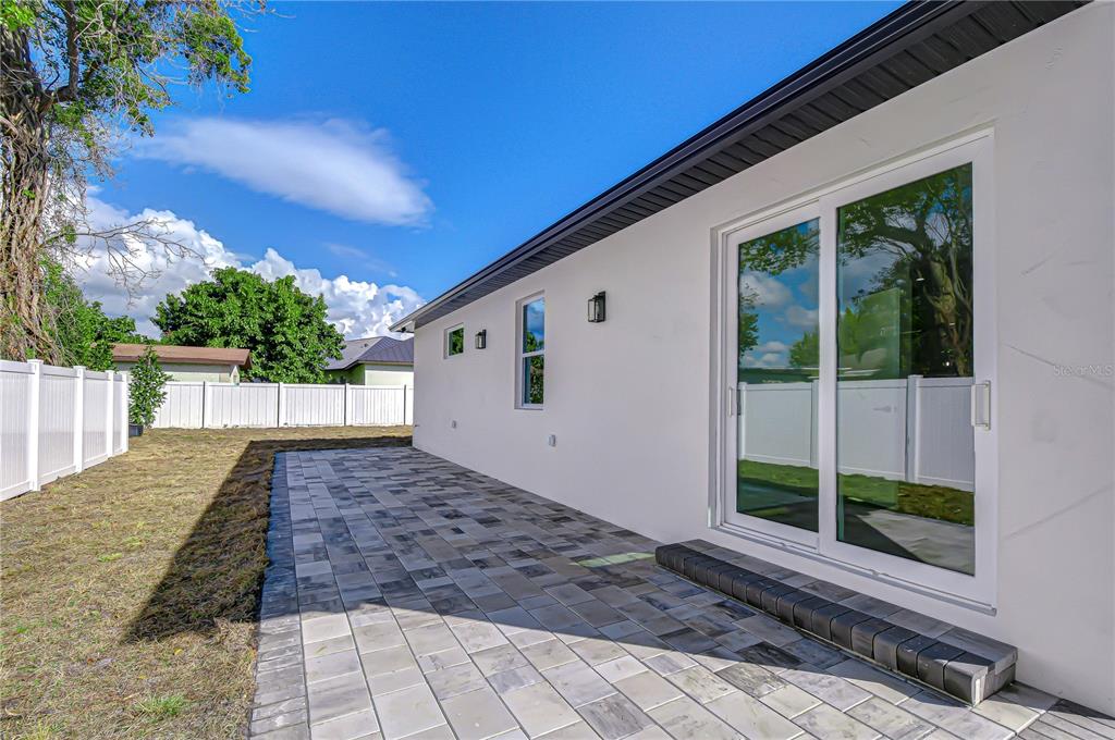 3213 West Aileen Street Tampa, FL 33607 - Photo 7 of 31 a view of a backyard with floor to ceiling window and wooden fence