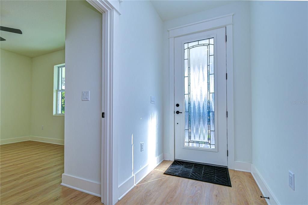 3213 West Aileen Street Tampa, FL 33607 - Photo 8 of 31 a view of an empty room with wooden floor and a window