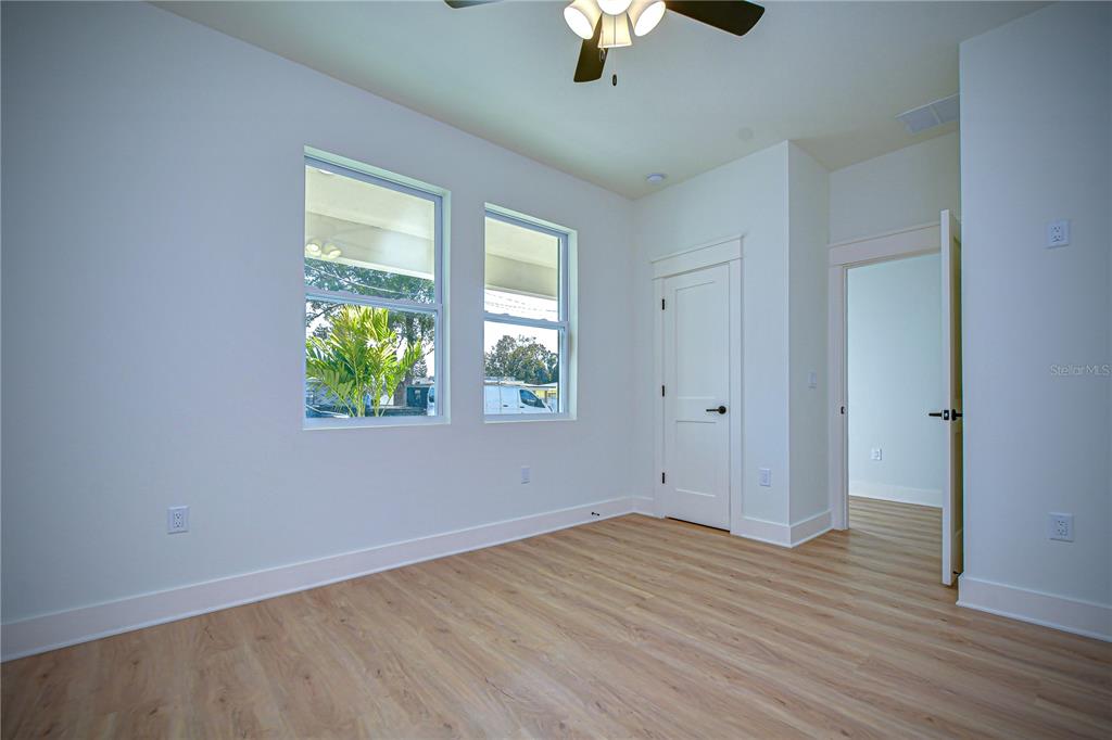 3213 West Aileen Street Tampa, FL 33607 - Photo 9 of 31 wooden floor in an empty room with a window