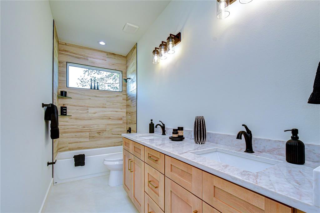 3213 West Aileen Street Tampa, FL 33607 - Photo 10 of 31 a bathroom with a sink and a mirror