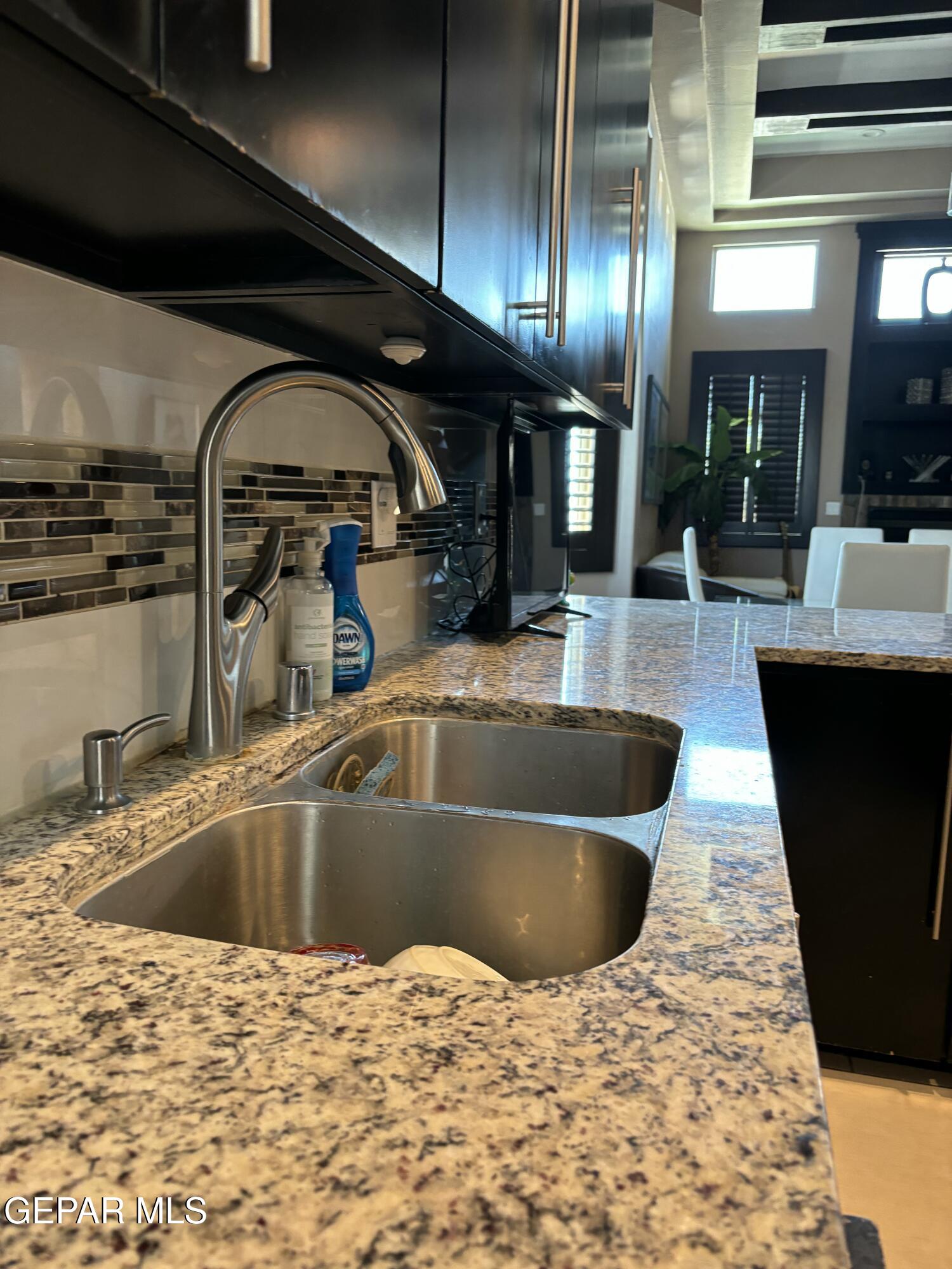317 Rio Del Rancho Court El Paso, TX 79932 - Photo 4 of 25 a kitchen with a sink and chandelier