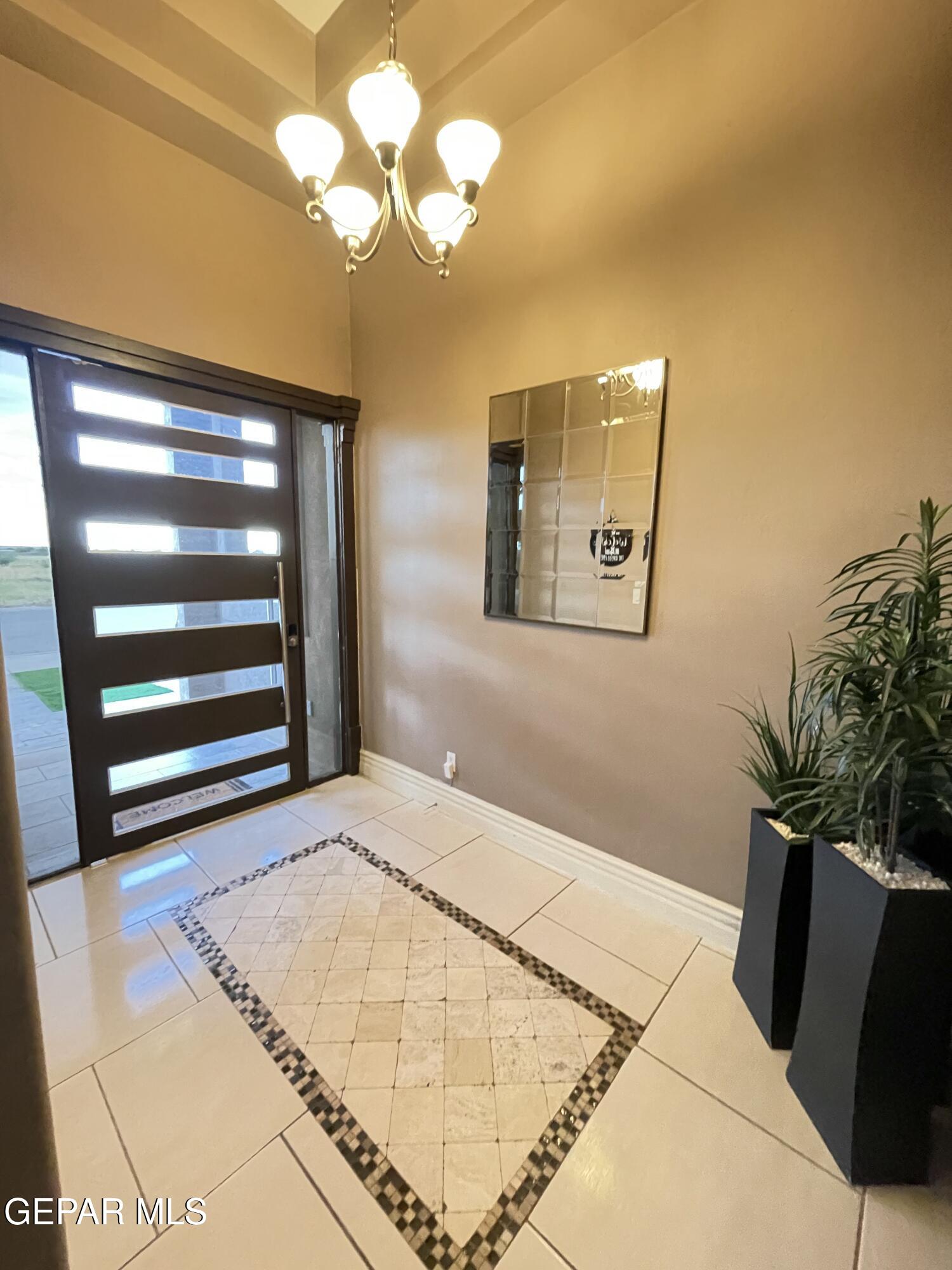 317 Rio Del Rancho Court El Paso, TX 79932 - Photo 6 of 25 a bedroom with a bed and a potted plant