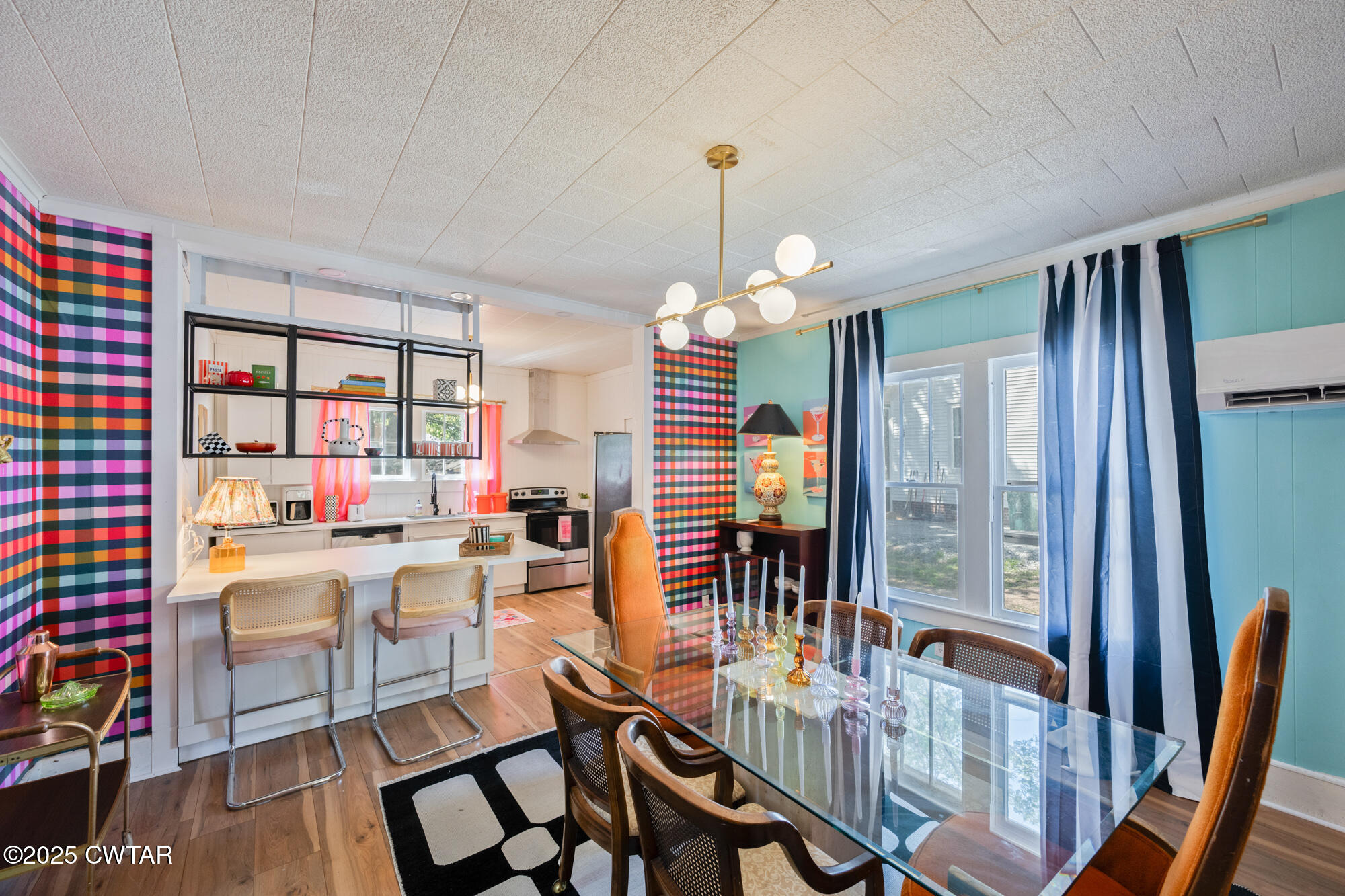 a dining room with furniture a rug and a chandelier