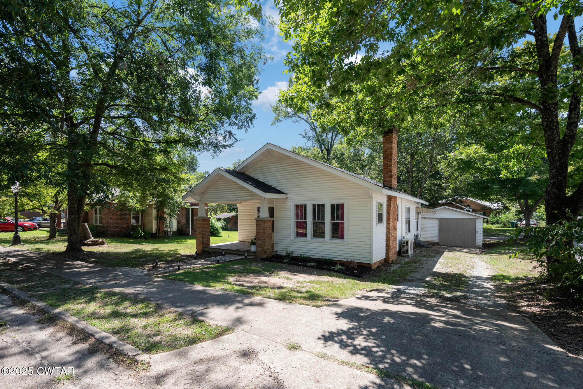 13185 Paris Street Huntingdon, TN 38344 - Photo 13 of 14 a house with trees in the background