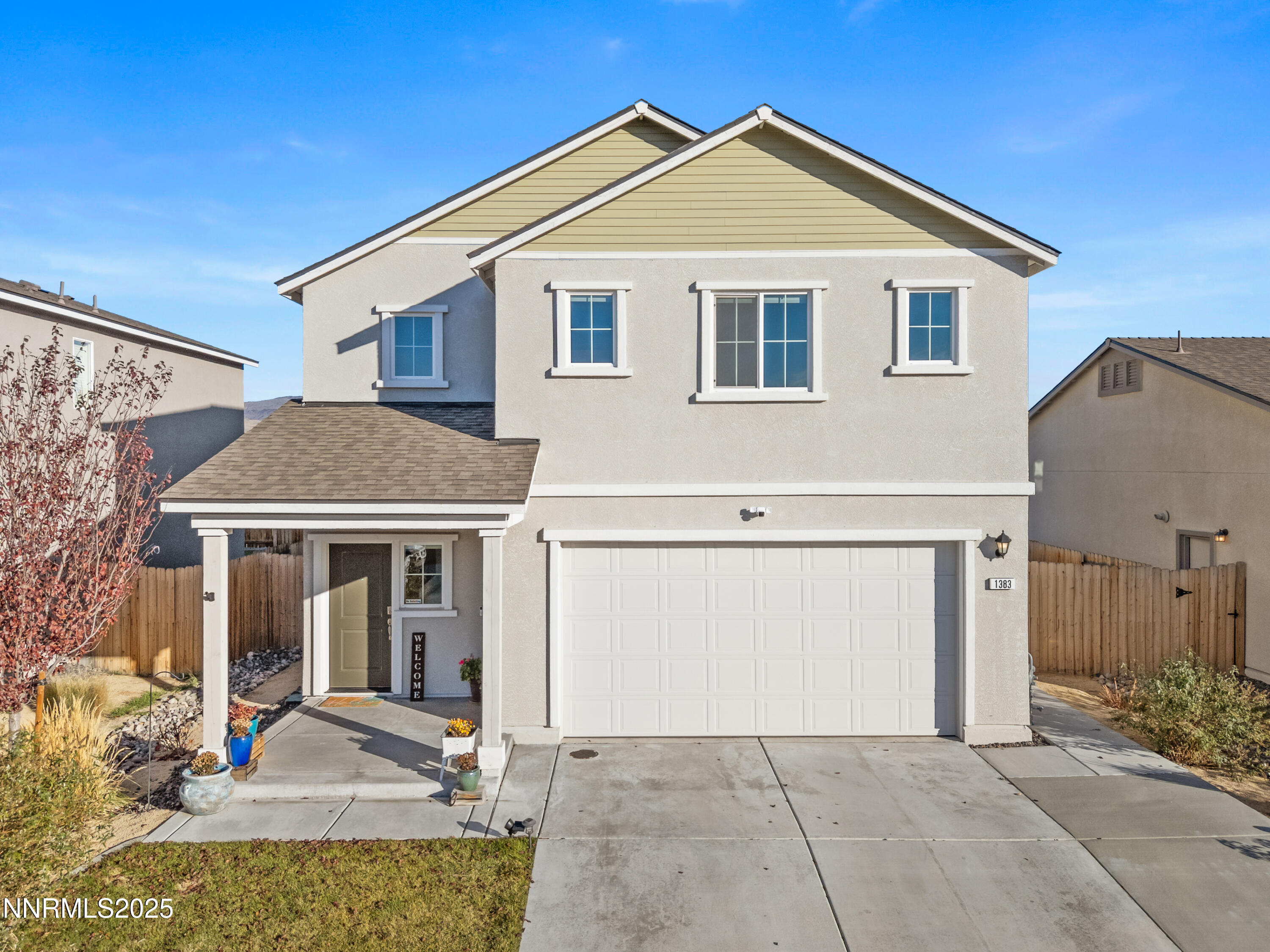1383 Old Barn Road Sparks, NV 89436 - Photo 14 of 44 a view of a white house with large windows and a small yard