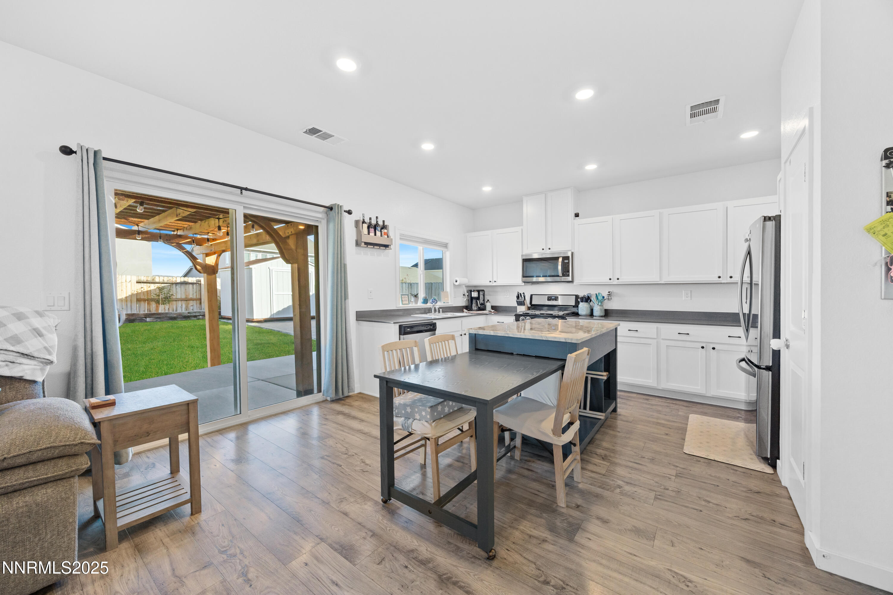 1383 Old Barn Road Sparks, NV 89436 - Photo 23 of 44 a kitchen with a table chairs refrigerator and microwave