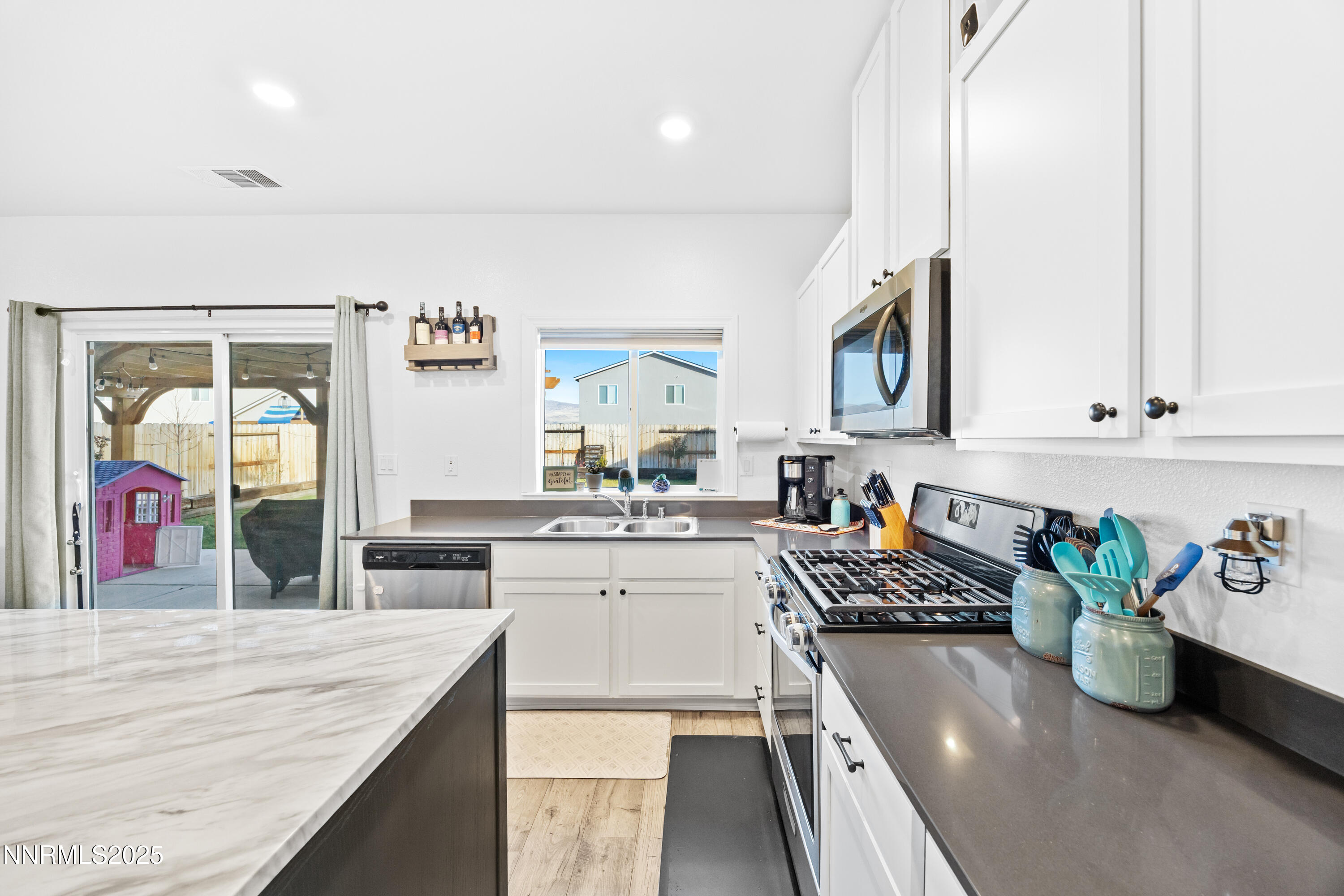 1383 Old Barn Road Sparks, NV 89436 - Photo 26 of 44 a kitchen with sink refrigerator and stove