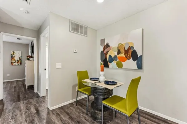 a view of a dining room with furniture and wooden floor