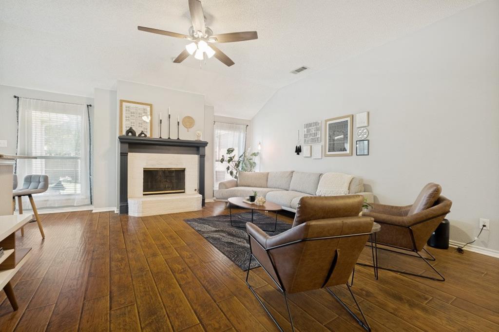 11709 Harbor Road Frisco, TX 75035 - Photo 2 of 12 a living room with furniture and a fireplace