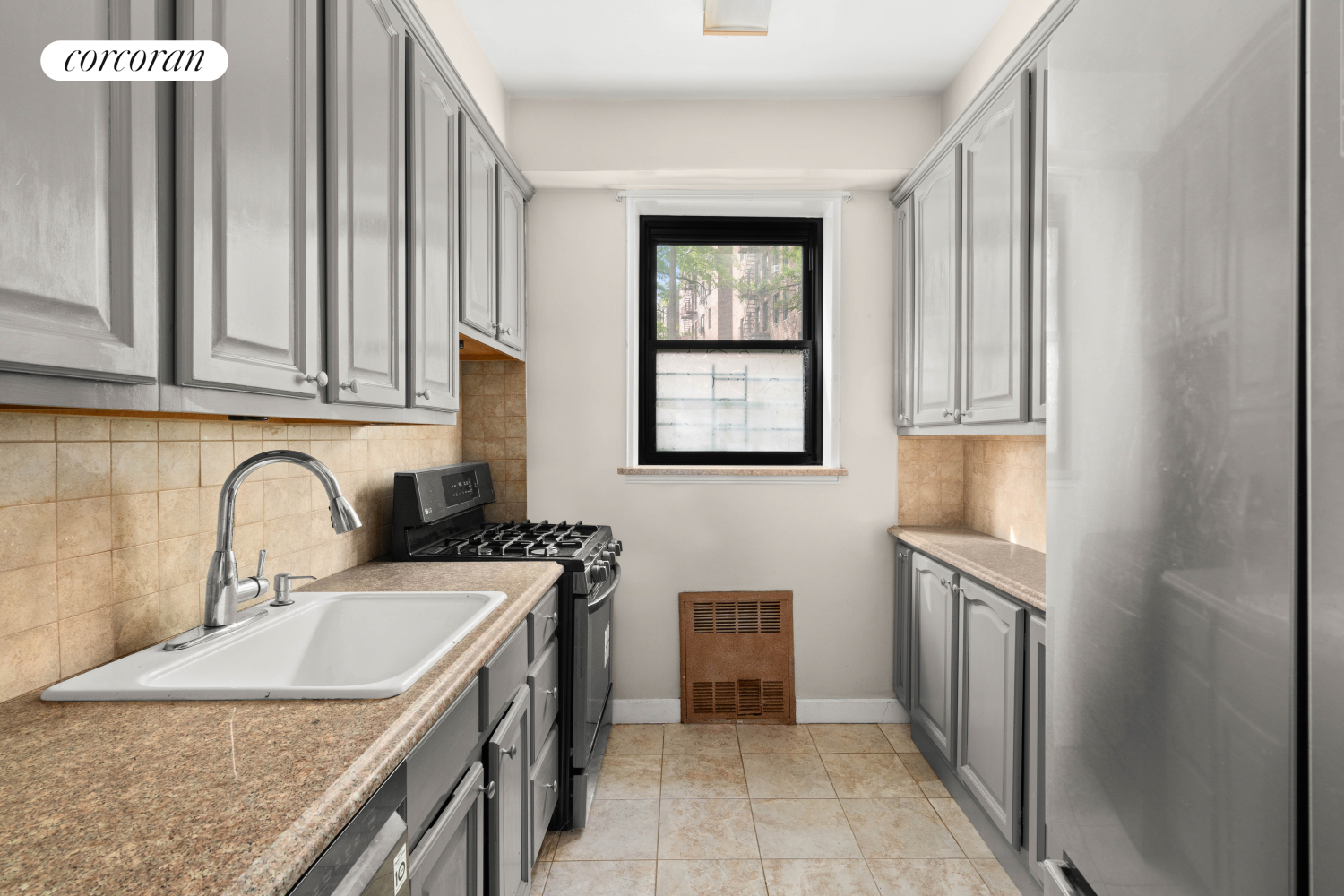 139-15 83rd Avenue, Unit 127 Queens, NY 11435 - Photo 4 of 9 a kitchen with stainless steel appliances granite countertop a sink stove and refrigerator