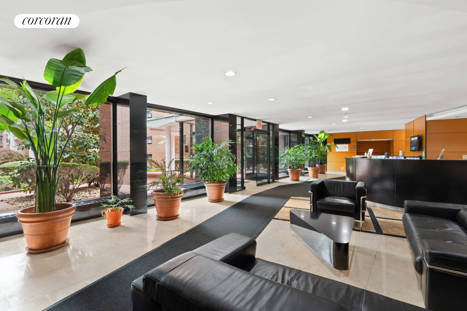 139-15 83rd Avenue, Unit 127 Queens, NY 11435 - Photo 7 of 9 a lobby with furniture and a potted plant