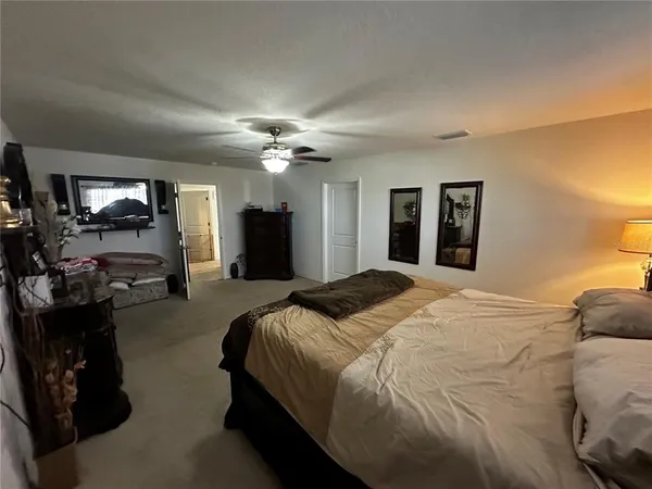 a bed room with a bed and a chandelier