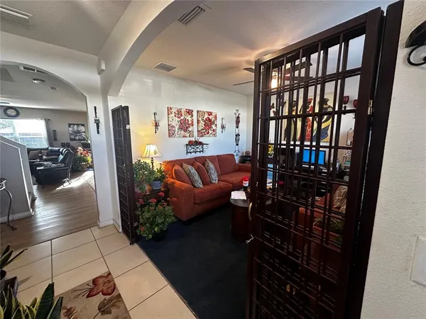 a living room with furniture and a floor to ceiling window