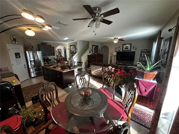 a living room with lots of chairs and a chandelier