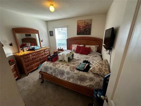 a bedroom with two beds and a flat screen tv
