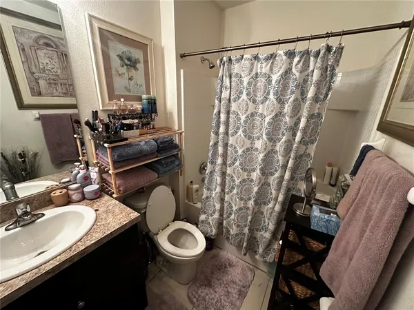 a bathroom with a sink mirror vanity and toilet