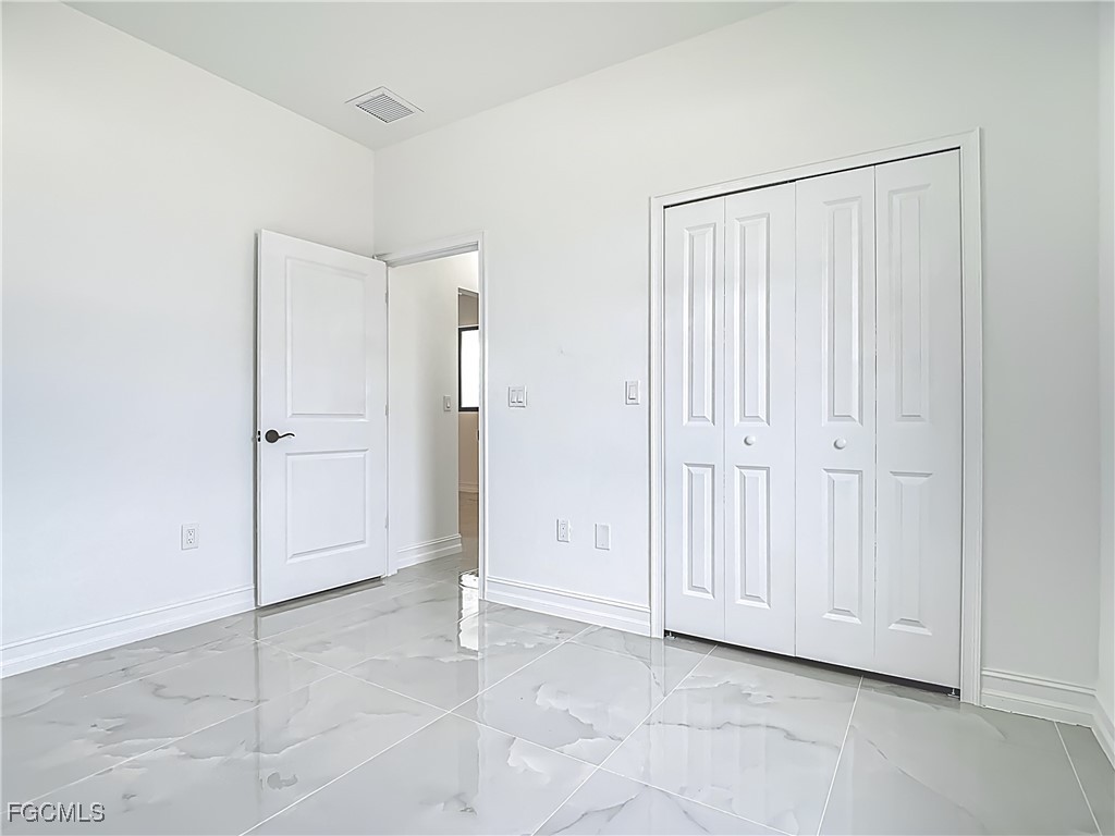 3705 8th Street Southwest Lehigh Acres, FL 33976 - Photo 19 of 34 an empty room with a door
