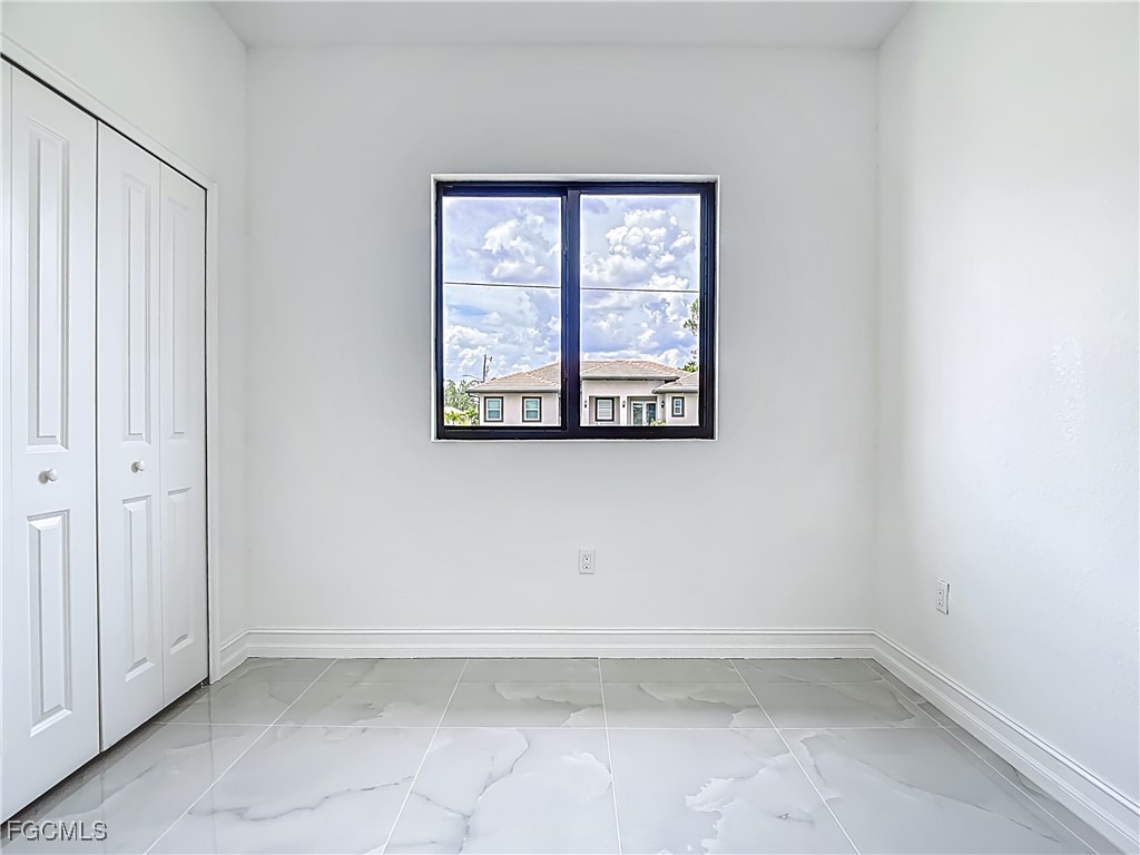 3705 8th Street Southwest Lehigh Acres, FL 33976 - Photo 20 of 34 an empty room with a window