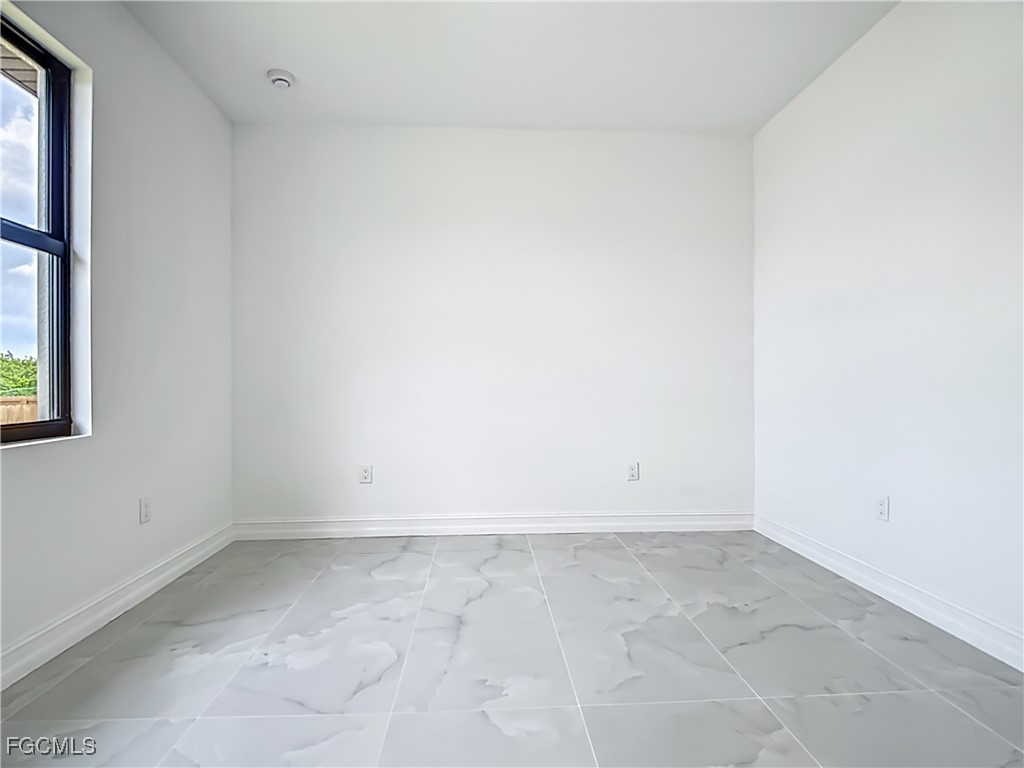 3705 8th Street Southwest Lehigh Acres, FL 33976 - Photo 21 of 34 an empty room with a window