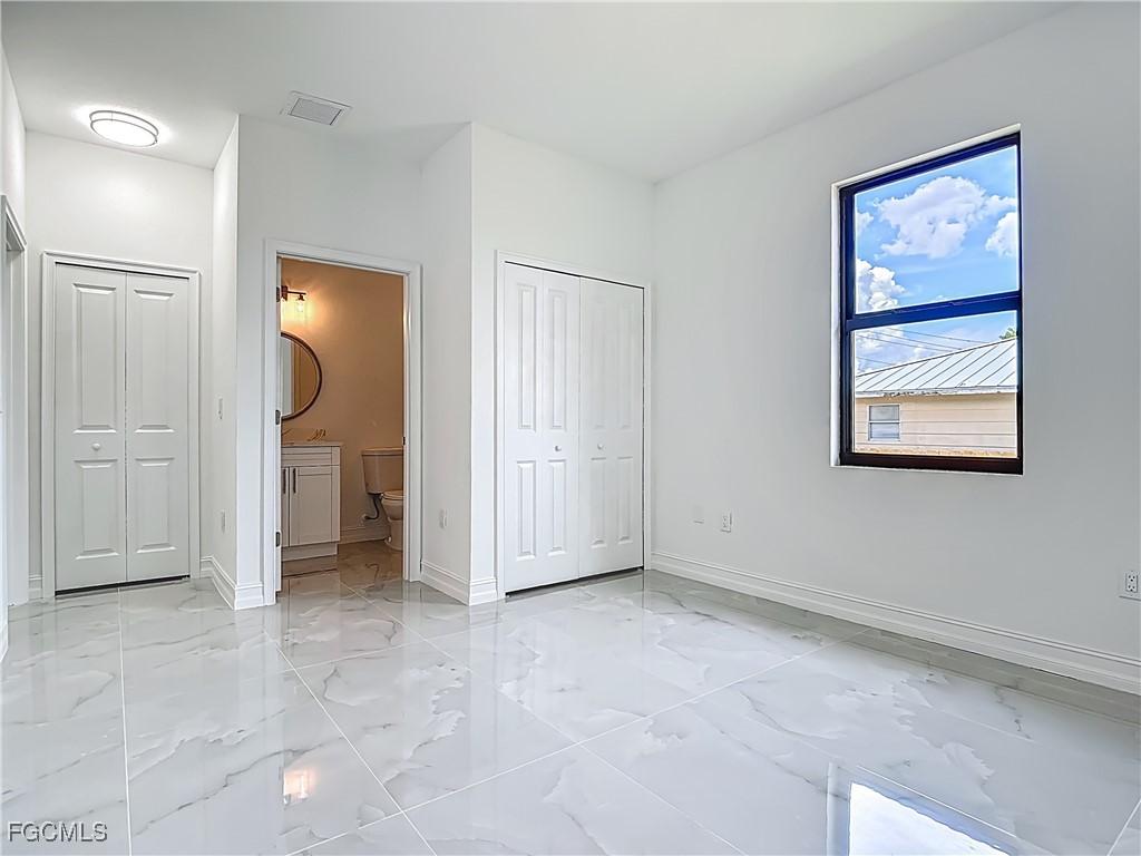 3705 8th Street Southwest Lehigh Acres, FL 33976 - Photo 23 of 34 an empty room with a cabinet and mirror