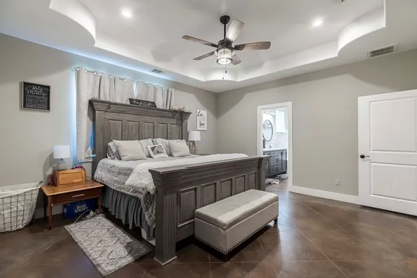 a bedroom with a bed and a chandelier