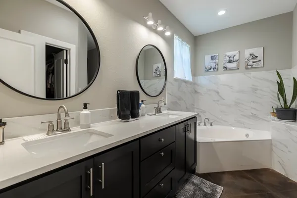 a bathroom with a double vanity sink and a mirror