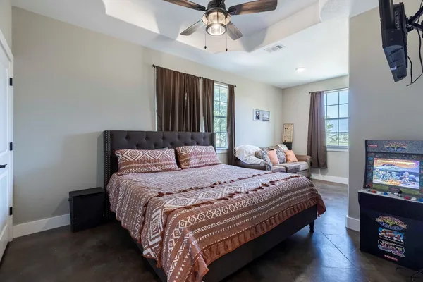 a bedroom with bed and a tv