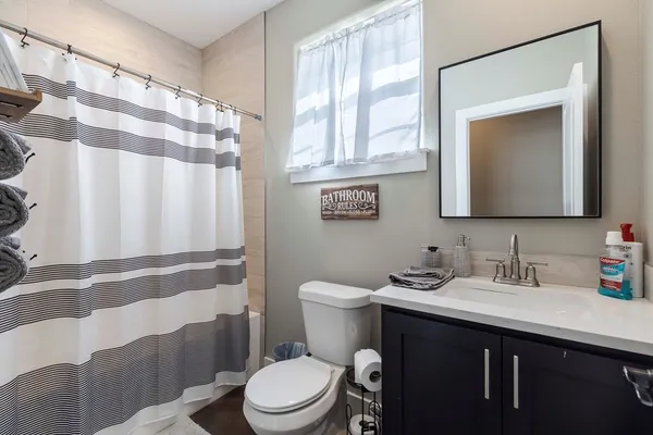 a bathroom with a toilet a sink and a mirror