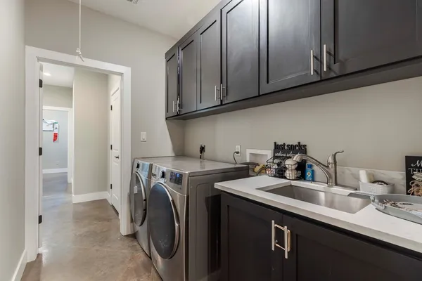 a utility room with sink dryer and washer