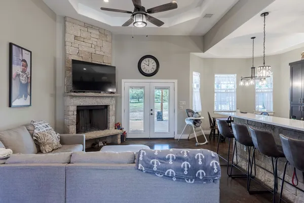 a living room with furniture a fireplace and a flat screen tv