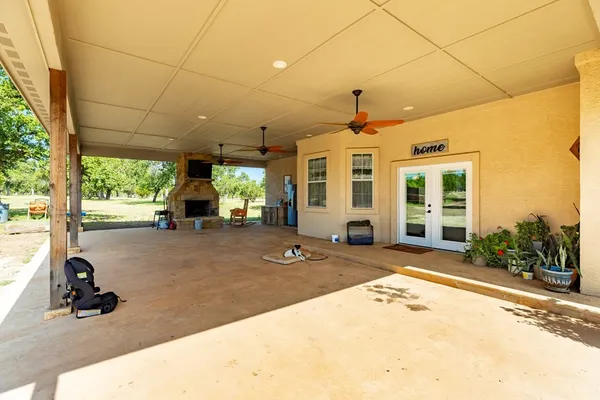 a view of a patio with a table and chairs under an umbrella