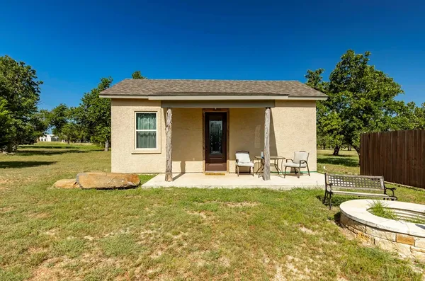 a view of a house with backyard porch and sitting area