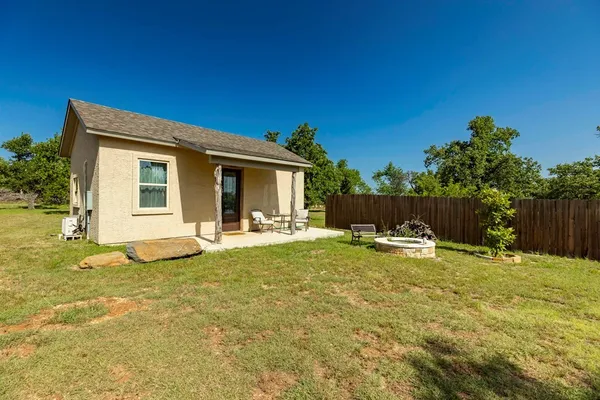 a view of a house with backyard and sitting area