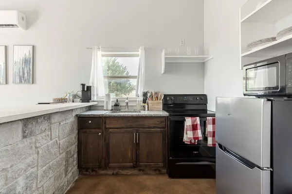 a kitchen with a refrigerator and a stove
