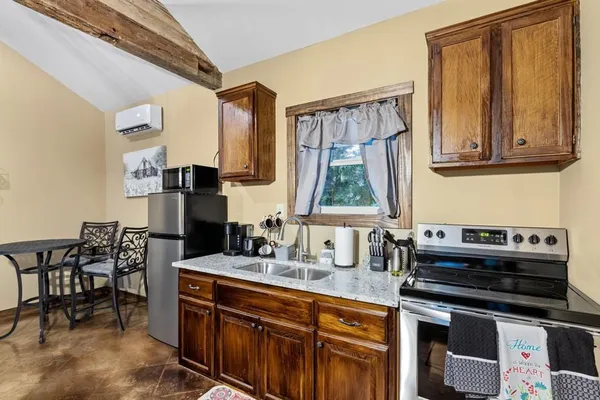 a kitchen with stainless steel appliances a stove a sink and a refrigerator