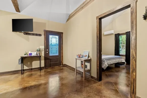 a bedroom with furniture and a window