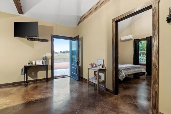 a bedroom with a bed and a flat screen tv