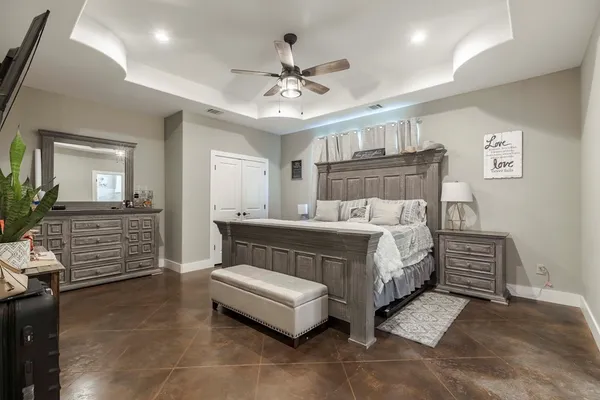 a bedroom with a bed and ceiling fan