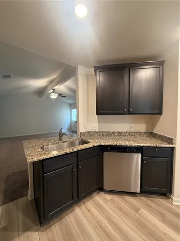 a kitchen with a sink and a mirror