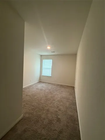 a view of an empty room and a window